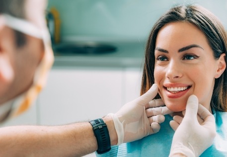 In network dentist examining dental patient's smile