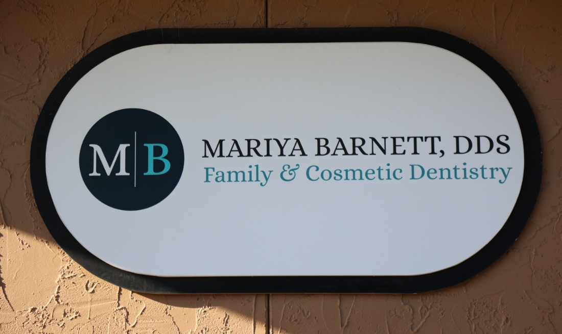 Mariya Barnett, DDS Family & Cosmetic Dentistry logo sign on dental office wall
