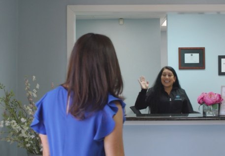 Dental team member greeting dental patient