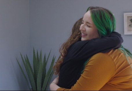 Dentist giving dental patient a hug