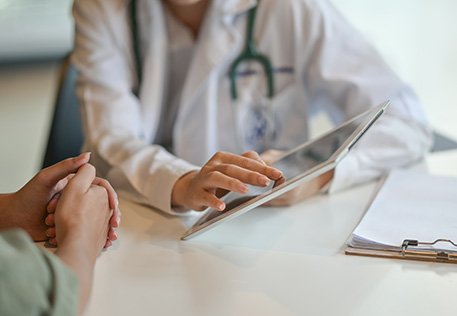 a doctor showing a patient a tablet