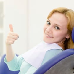Happy woman smiling in dental chair