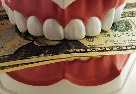 Money clenching in a pair of teeth