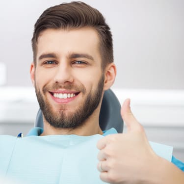smiling man in the dental chair