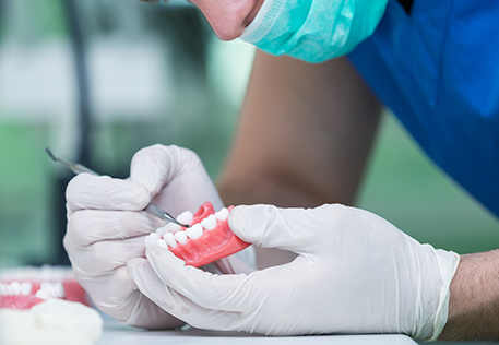 A dental worker making dentures