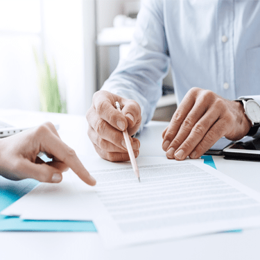 Patient and dental team member filling out forms