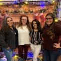Four dental team members in front of holiday decorations