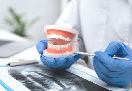 Dentist using smile model to explain how to prevent periodontal disease
