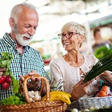 elderly couple buying fresh fruits and vegetables 