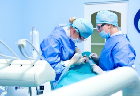 Dentist performing dental implant dentures procedure
