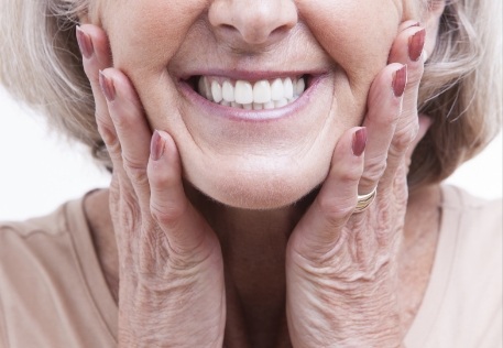 Woman enjoying the benefits of combining dentures and dental implants