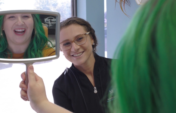 Dentist smiling at dental patient in Dallas treatment room