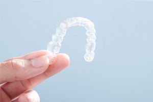 Patient holding clear aligner