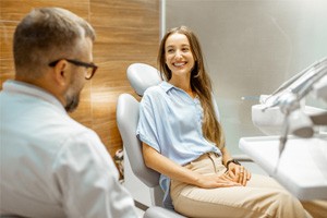 Female patient smiling at dentist at dental appointment