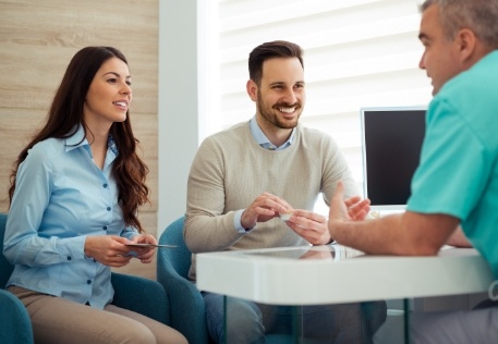 Dental patients talking to dentist during consultation visit