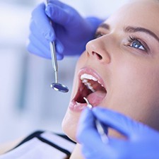 dentist examining a patient’s mouth 