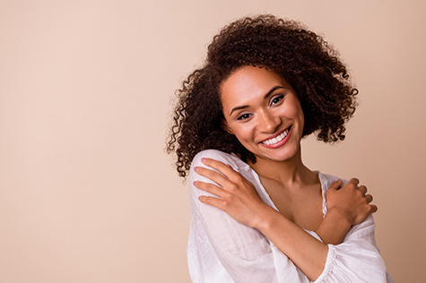 a woman crossing her arms and smiling 