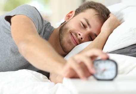 Man waking feeling rested thanks to sleep apnea therapy