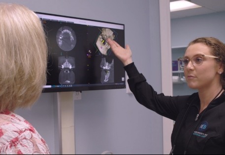 Dentist and dental patient looking digital x-rays