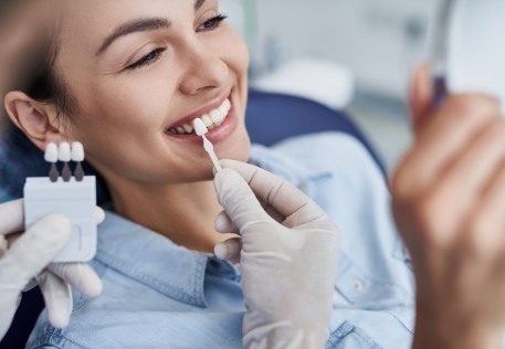 Woman looking at smile after veneers