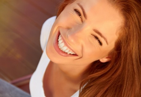 Woman enjoying beautiful smile after teeth whitening