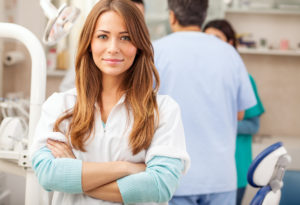 Woman safety champion at dentist in Dallas folding arms