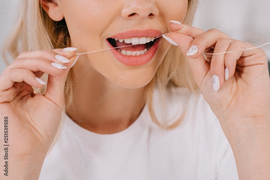 Patient flossing with Invisalign