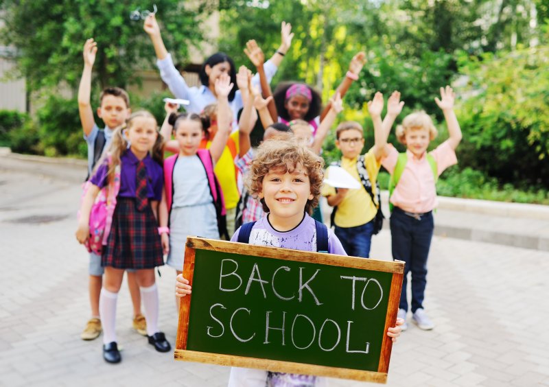 A group of children preparing to go back to school while prepared for dental emergencies