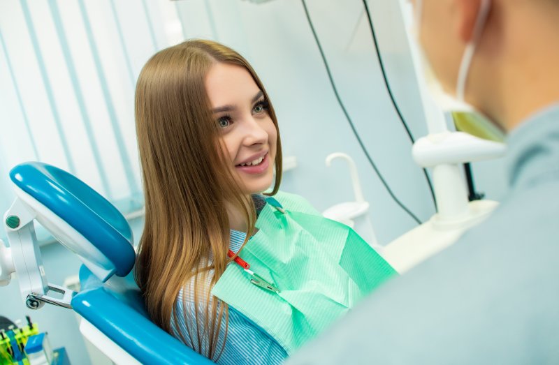 Woman smiling at her dentist after dental checkup