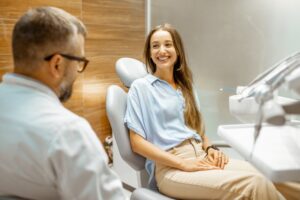 Young woman smiling at dentist.
